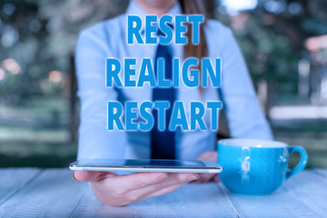 Handwriting text Reset Realign Restart. Conceptual photo Life audit will help you put things in perspectives Business woman sitting by the table with cup of coffee and mobile phone