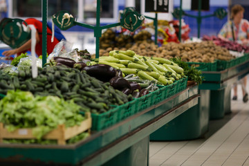 Eggplants and zucchini on the fruits and vegetables aisle in a store