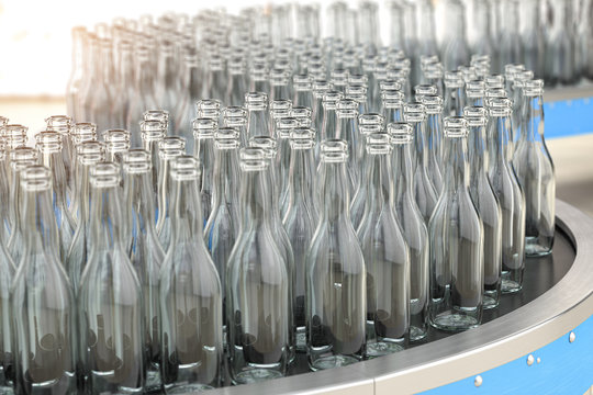 Empty  Glass Bottles On Conveyor Belt In Factory Or Glass Manufacture.