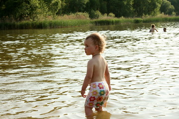 little girl standing in the lake in long underwear