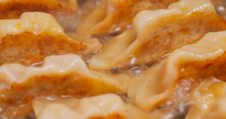 Fry meat dumpling on pan in kitchen