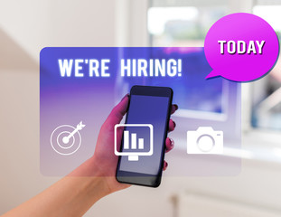 Text sign showing We Re Hiring. Business photo text process of reviewing applications and finding candidates woman icons smartphone speech bubble office supplies technological device