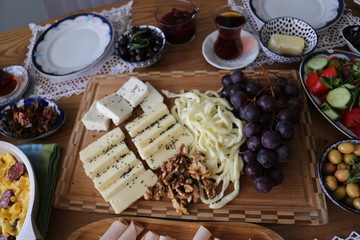 Huge healthy breakfast spread on a table with coffee, orange juice, fruit, muesli, smoked salmon, egg, croissants, meat and cheese.turkey