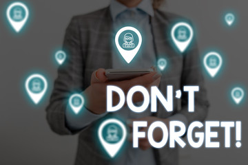 Handwriting text writing Don T Forget. Conceptual photo used to remind someone about important fact or detail Woman wear formal work suit presenting presentation using smart device