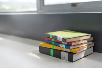 books stacked on the table at the university library in selective focus.