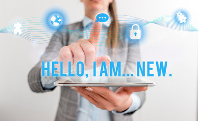 Conceptual hand writing showing Hello I Am New. Concept meaning introducing oneself in a group as fresh worker or student Female human wear formal work suit presenting smart device