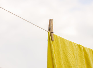 Freshly washed bed linen hanging on the rope outdoors.