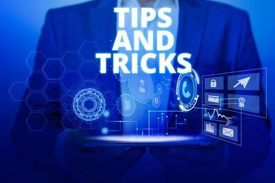 Text sign showing Tips And Tricks. Business photo text piece of inside facts specially in betting or investing Male human wear formal work suit presenting presentation using smart device