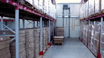 Rows of shelves with boxes in modern warehouse