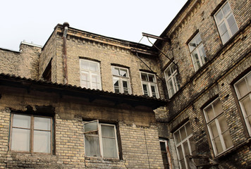 Fototapeta na wymiar Old town residential building walls with windows bottom-top view
