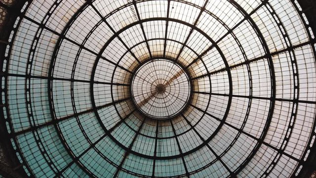 Milan, Italy - May 2019: Glass dome gallery Vittorio Emanuele. The concept of symmetry. All-round panorama. 