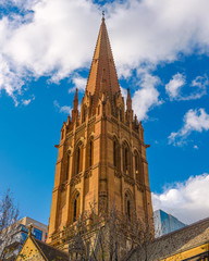 The church spire of St Paul's Cathedral in the city of Melbourne, Australia, set against a blue sky day.