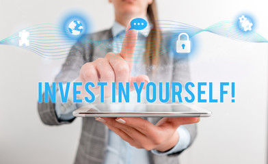 Conceptual hand writing showing Invest In Yourself. Concept meaning nvesting in a coach or a training to learn new things Female human wear formal work suit presenting smart device