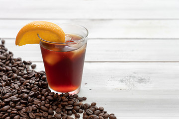Ice Cold brew coffee with lemonade on white wooden.