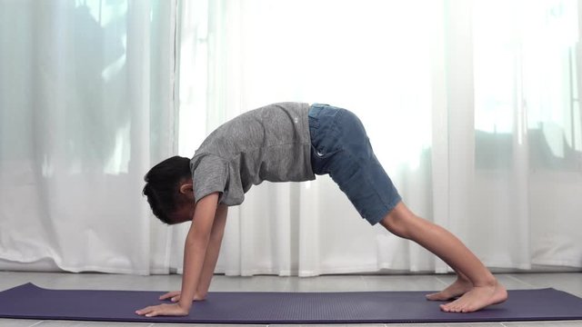 4k Young Asian boy do yoga by himeself