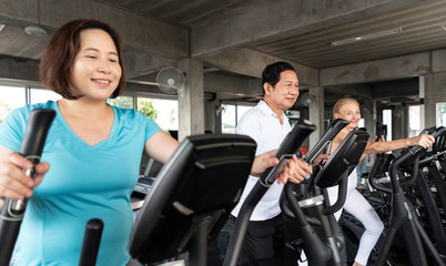Fototapeta na wymiar Group of senior exercise jogging at gym fitness smiling and happy. elderly healthy lifestyle.