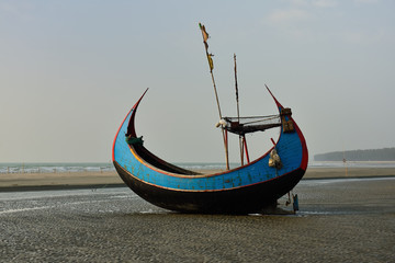 The traditional fishing boat (Sampan Boats) moored on the longest beach, Cox's Bazar in Bangladesh.