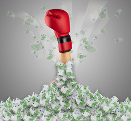 Human hand buried in euro pile and trying to break out