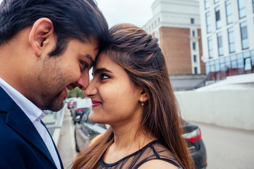Naklejka premium indian woman in long evening blue dress spinding romantic time together with lover handsome boyfriend europe urban downtown city