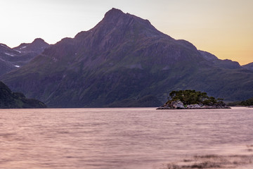 It`s a white night on the Lofoten Islands in Norway.    Tranquil views of the Innerfjorden and small island Brynnelslåttholmen. The photo was taken with a long exposure.
