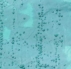 Fototapeta na wymiar Raindrops on a tent as an abstract background