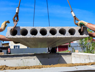 A crane raised a concrete slab at a construction site at home