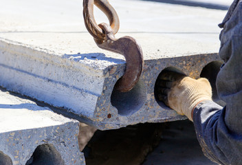 Installing concrete slabs at a construction site at home