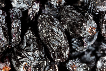 Black dry raisins as background