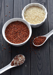 red and steamed rice in a ceramic bowls and spoons