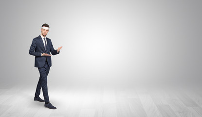 Young businessman in suit fighting in an empty space