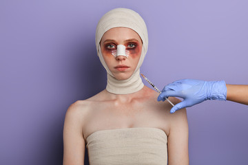 doctor going to kill the patient, close up portrait, isolated blue background, studio shot,killer ,...