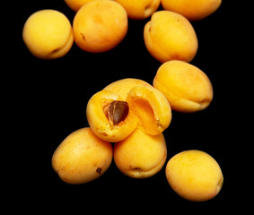 Ripe apricot on a black background