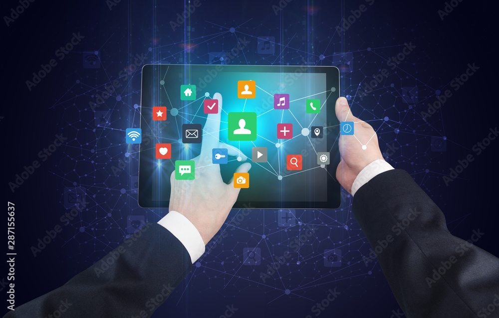 Poster Hand using tablet with colorful bounce application symbols and icons concept