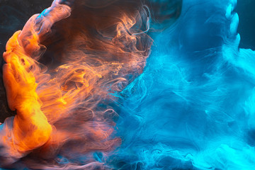 Ink water mix. Magic burst. Blue orange paint blend. Abstract art background.