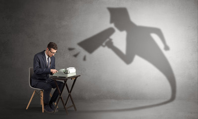 Hard working businessman shadow yelling to himself concept