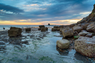 Fototapeta na wymiar The rocky shoreline of Saltwick Bay