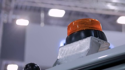 Close up of warning orange beacon flashing on roof of emergency, support and service vehicle. Danger, legal, alert light, attention and hazard concept