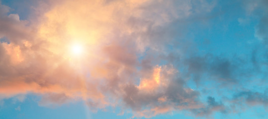 Beautiful sunrise on cloudy sky. Wide photo.