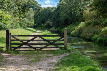 Gate alongside a river footpath