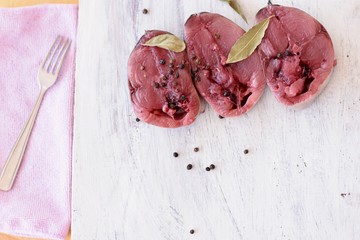 Closeup of raw traditional raw Bonito tuna fish fillet whit black pepper and sage ready for cooking/ Closeup food background