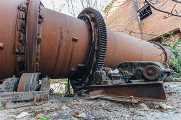 Old rusty rotating kiln in cement manufacturing plant