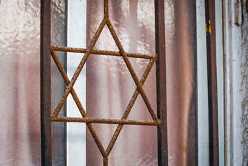 Metal grille in the form of six pointed star of David closeup in Netanya, Israel