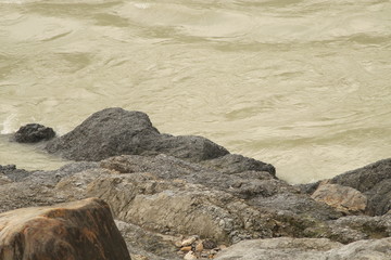 Fototapeta na wymiar Mountain fast flowing river stream of water in the rocks