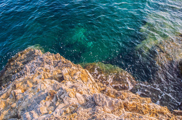 Water surface and rocks stones on sea floor