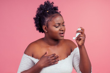 African american woman over isolated pink background feeling unwell and coughing as symptom for...