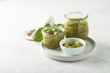 Homemade pesto sauce in jars
