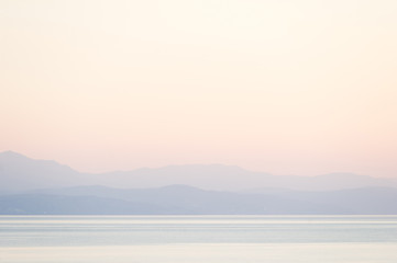 Mountain view on the horizon in light fog over the Black Sea at sunrise
