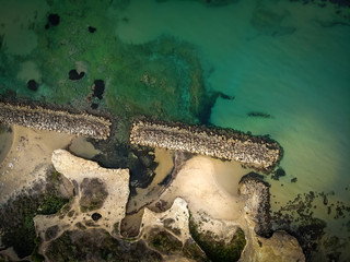 Aerial shot of the Cirica Bay at sunrise. Cirica is a beautiful nature seaside place made of cliffs, rocks and sand in the southern Sicily, Italy