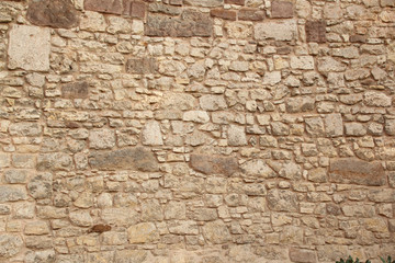 rough sandy texture of an old medieval stone wall. Background for design, close-up, copy space