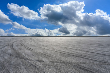 Empty race track road and blue sky with white clouds